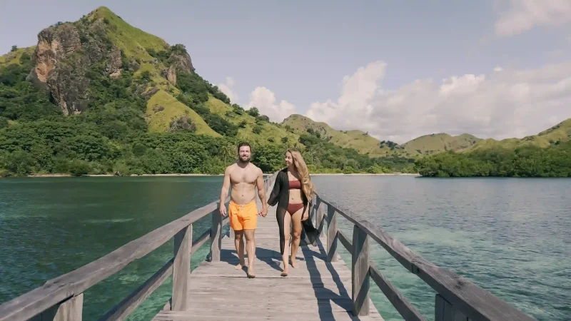 A couple walking the jetty at Manjarite Island, Komodo